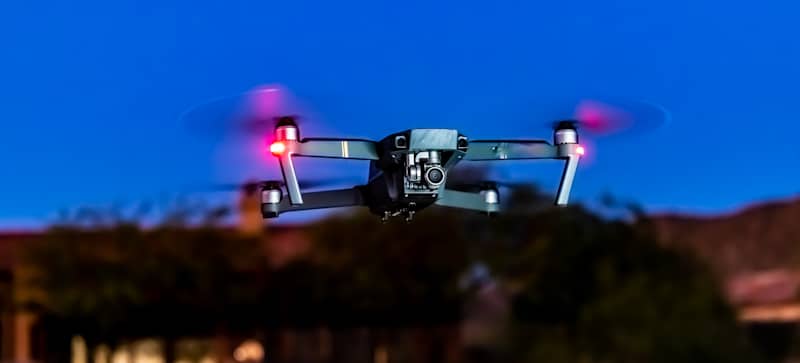 drone hovers in place with pink lights