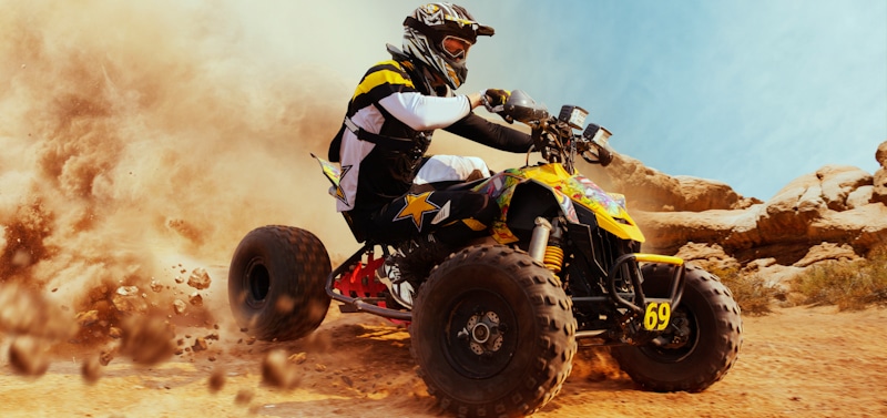 man rides atv in competition