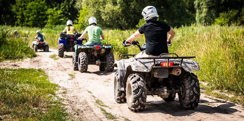 group rides atv in the woods