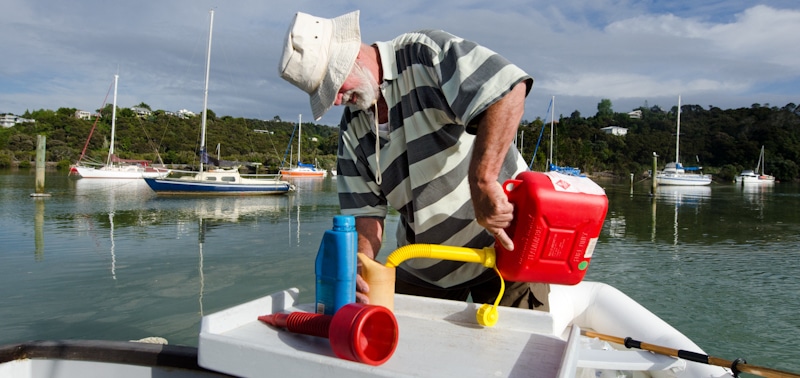 man pours gas on boat