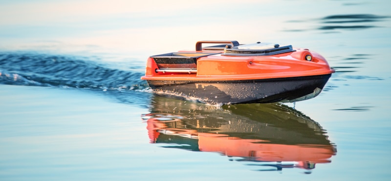 red rc boat in water