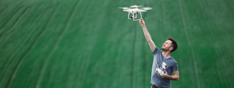 holding white drone