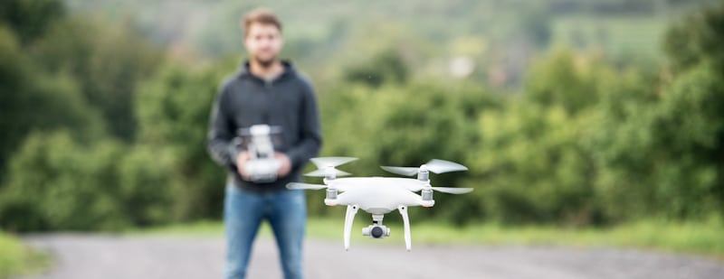 man flying white drone