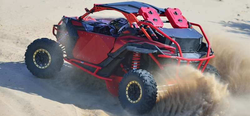 red atv racing in sand