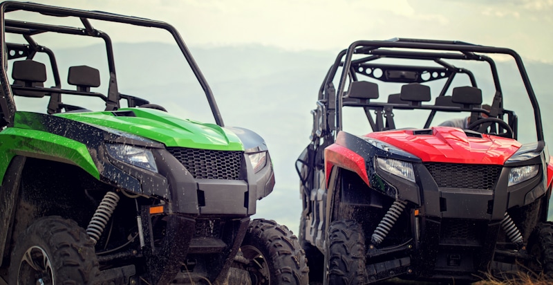 two atvs green and red