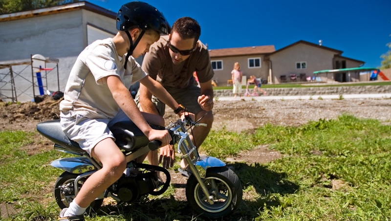father and son teach bikes