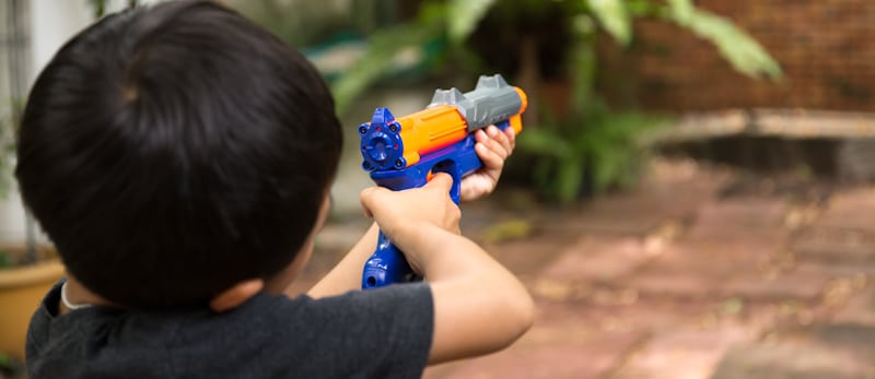 little kid playing gun