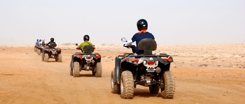atv riders on desert